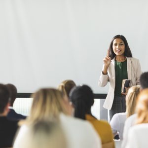 Businesswoman of Indian descent speaking at a seminar